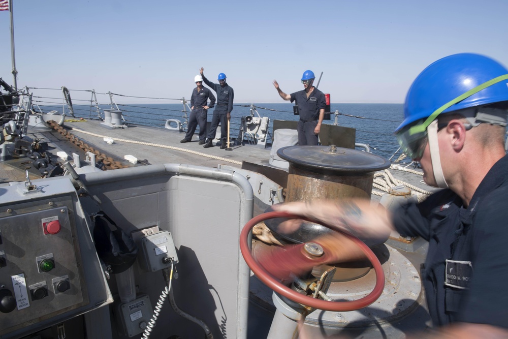 U.S. Navy Sailors drop the anchor aboard the guided-missile destroyer USS Spruance (DDG 111) off the coast of Duqm, Oman