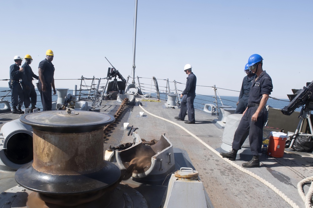 U.S. Navy Sailors drop the anchor aboard the guided-missile destroyer USS Spruance (DDG 111) off the coast of Duqm, Oman