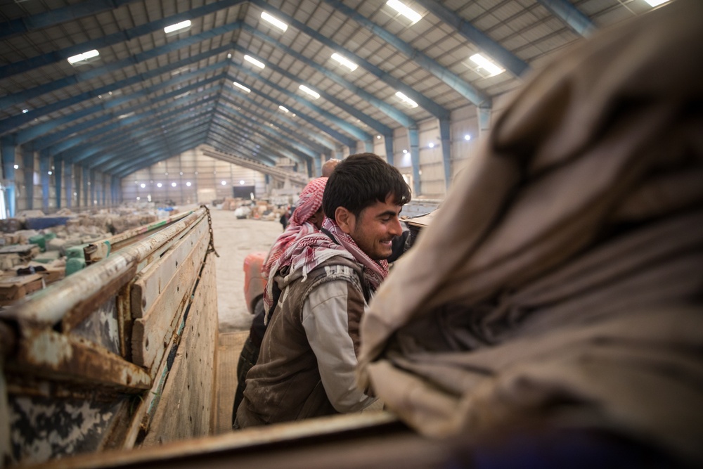 Coalition Forces members distribute pallets of medical supplies to SDF, local doctors
