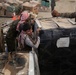 Coalition Forces members distribute pallets of medical supplies to SDF, local doctors