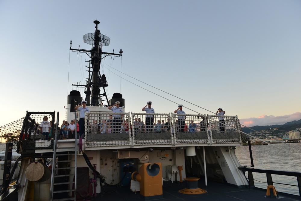 Past and present Coast Guard Cutter Sherman crewmembers honor the cutter’s final colors