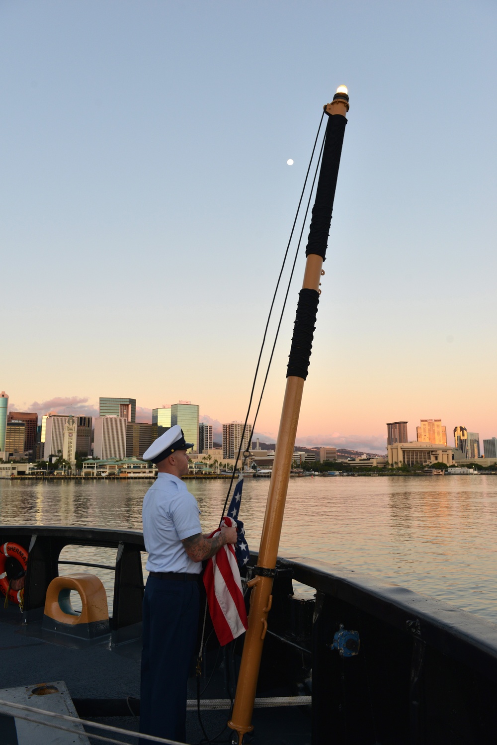 Past and present Coast Guard Cutter Sherman crewmembers honor the cutter’s final colors