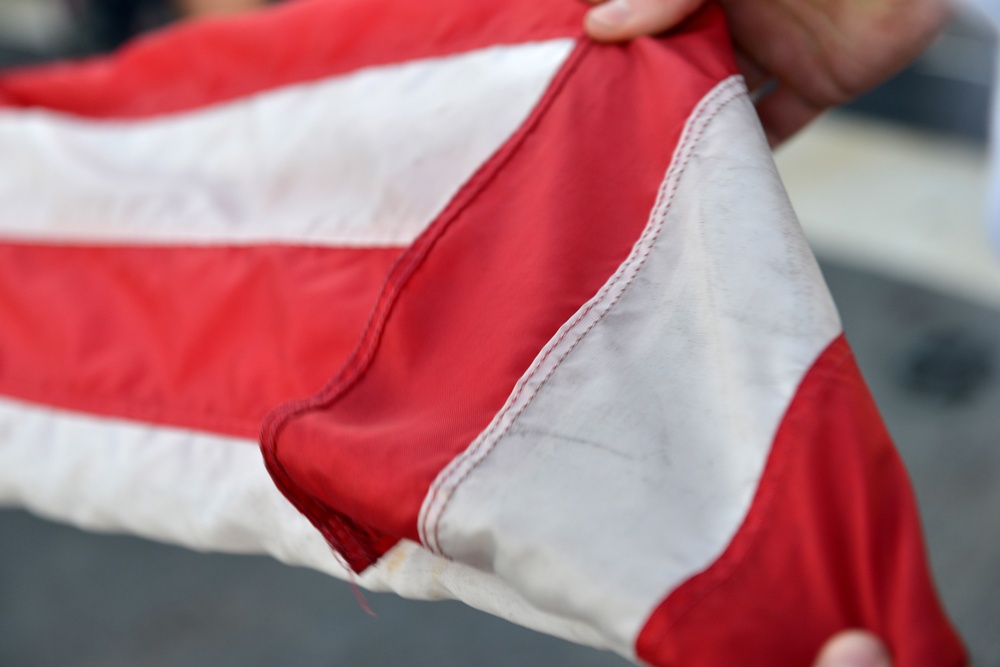 Past and present Coast Guard Cutter Sherman crewmembers honor the cutter’s final colors