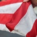 Past and present Coast Guard Cutter Sherman crewmembers honor the cutter’s final colors