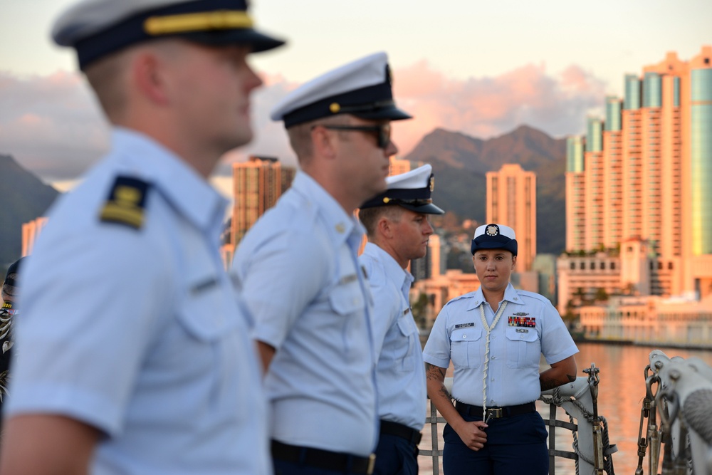 Past and present Coast Guard Cutter Sherman crewmembers honor the cutter’s final colors