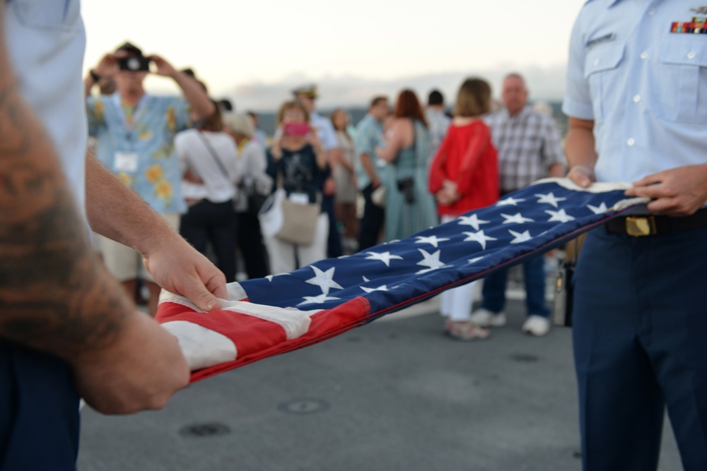 Past and present Coast Guard Cutter Sherman crewmembers honor the cutter’s final colors