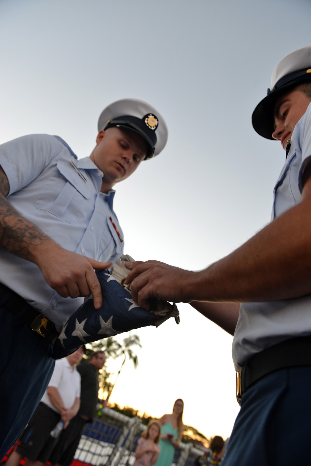 Past and present Coast Guard Cutter Sherman crewmembers honor the cutter’s final colors