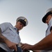 Past and present Coast Guard Cutter Sherman crewmembers honor the cutter’s final colors