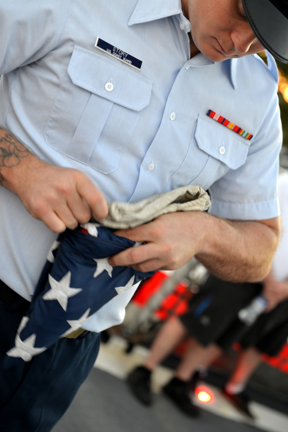 Past and present Coast Guard Cutter Sherman crewmembers honor the cutter’s final colors