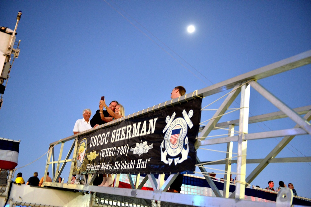 Past and present Coast Guard Cutter Sherman crewmembers honor the cutter’s final colors