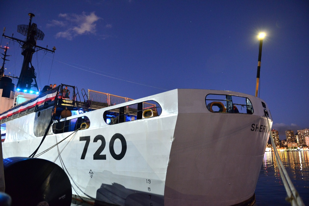 Past and present Coast Guard Cutter Sherman crewmembers honor the cutter’s final colors