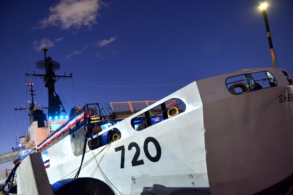 Past and present Coast Guard Cutter Sherman crewmembers honor the cutter’s final colors