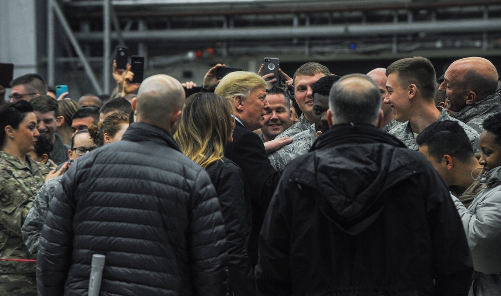 President Donald Trump and first lady Melania Trump pose for photos with U.S. Airmen on Ramstein Air Base, Germany