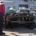 U.S. Sailors, assigned to Helicopter Maritime Strike Squadron (HSM) 71, load an AGM-114 Hellfire missile