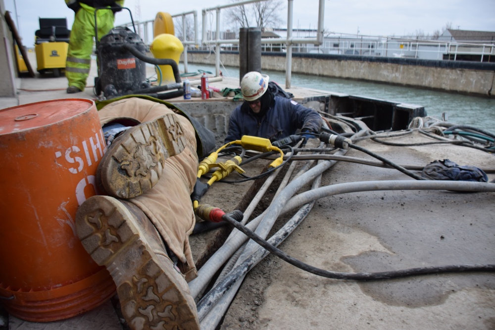 USACE Black Rock Lock employees position themselves to conduct repairs