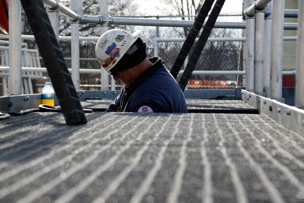 USACE Black Rock Lock employee works below walkway