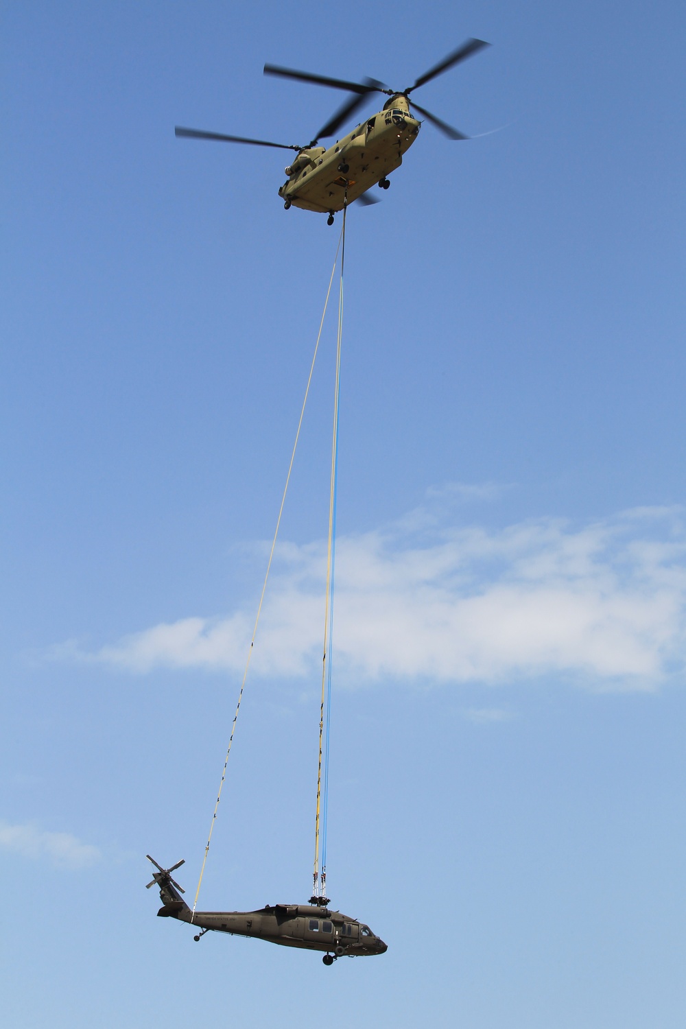 Chinook ferries helicopter to maintenance facility