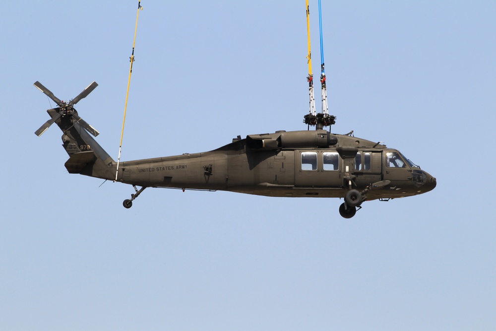 Chinook ferries helicopter to maintenance facility