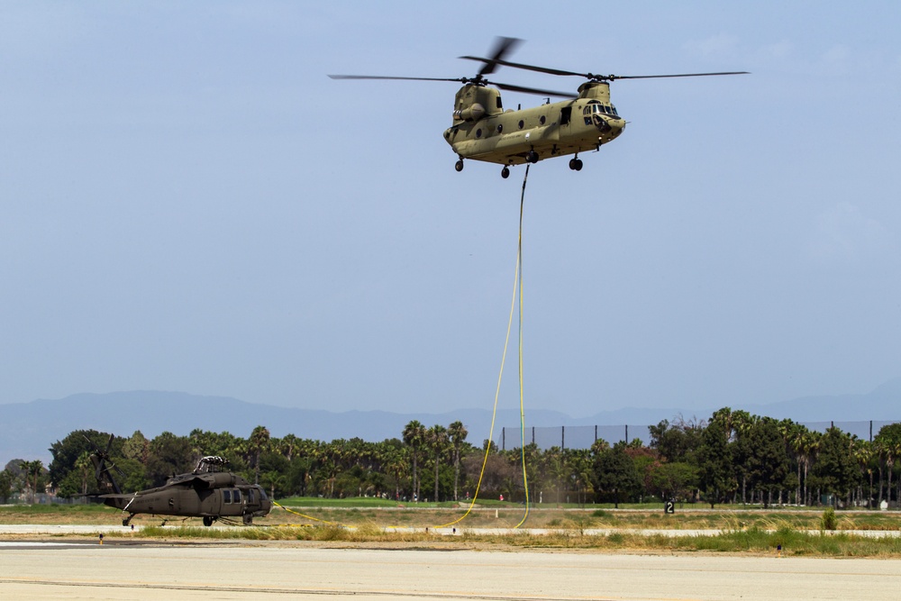 Chinook ferries helicopter to maintenance facility