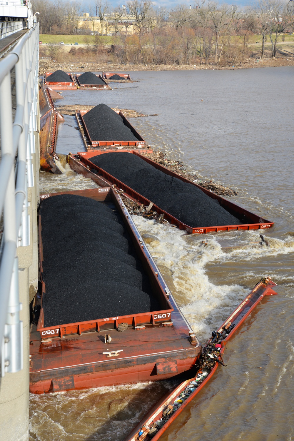 Barges pinned against McAlpine Dam on Ohio River