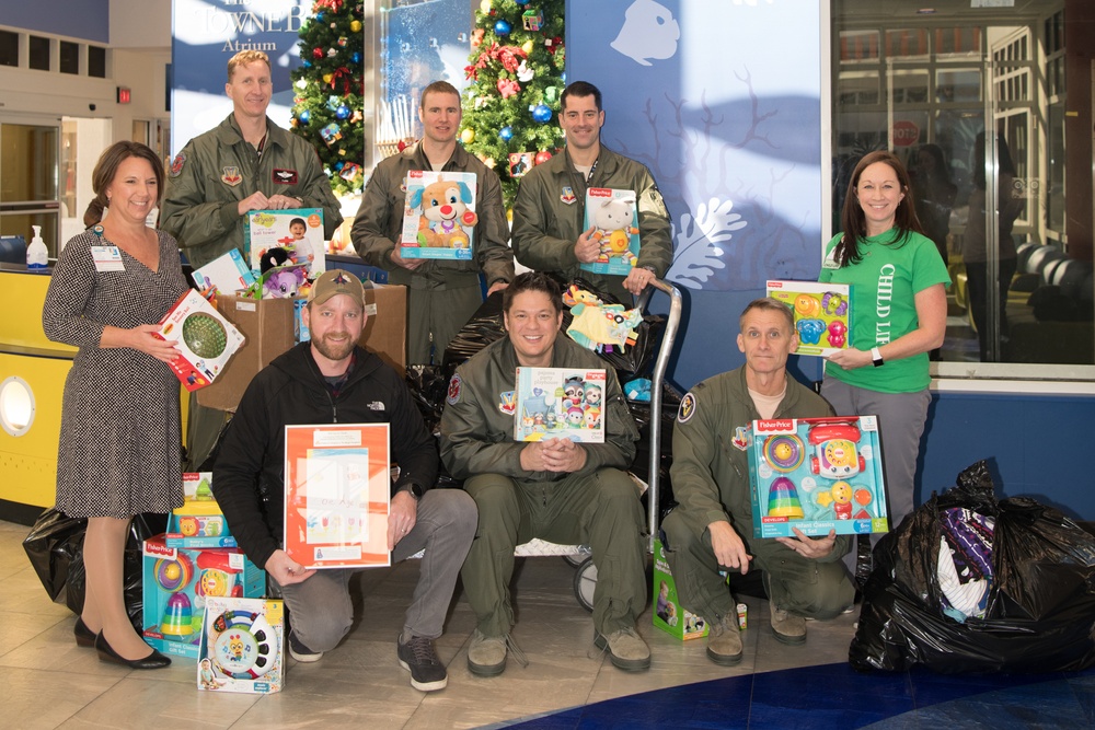 149th Fighter Squadron partners with community to donate toys to Children's Hospital