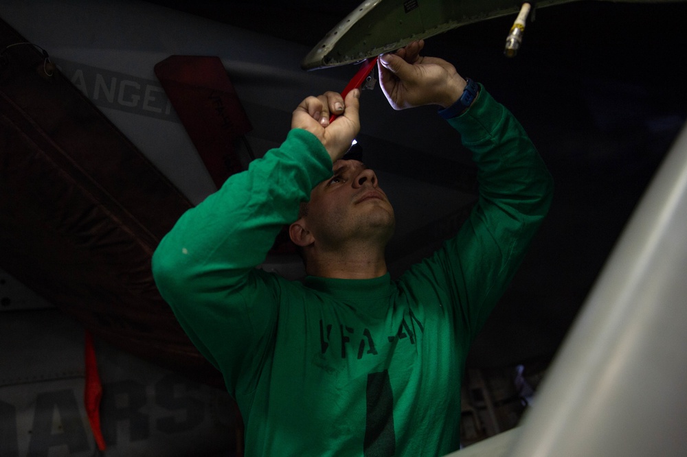 U.S. Sailor strips sealant aboard the aircraft carrier USS John C. Stennis (CVN 74)