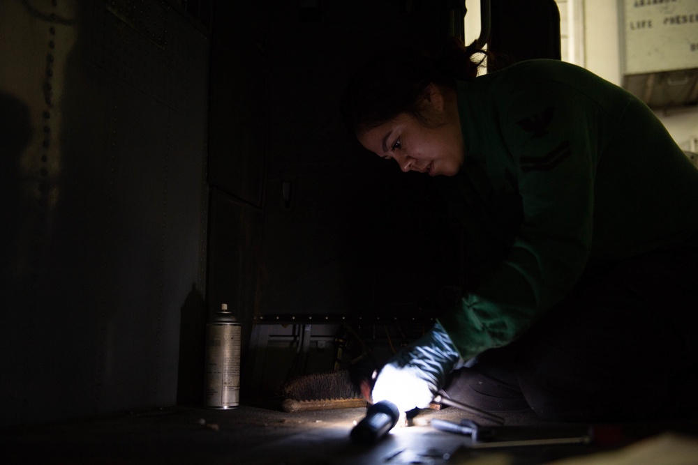 U.S. Sailor removes corrosion aboard the aircraft carrier USS John C. Stennis (CVN 74)