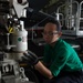 U.S. Sailor performs maintenance on landing gear