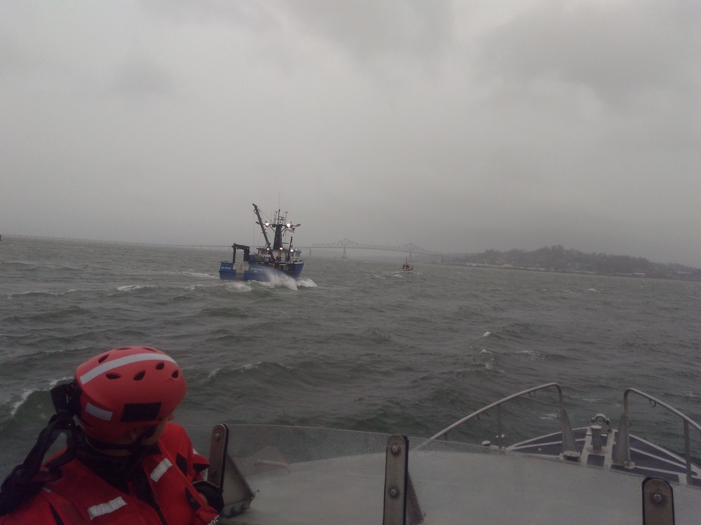 Coast Guard Station Cape Disappointment boat crews tow disabled fishing vessel through rough weather