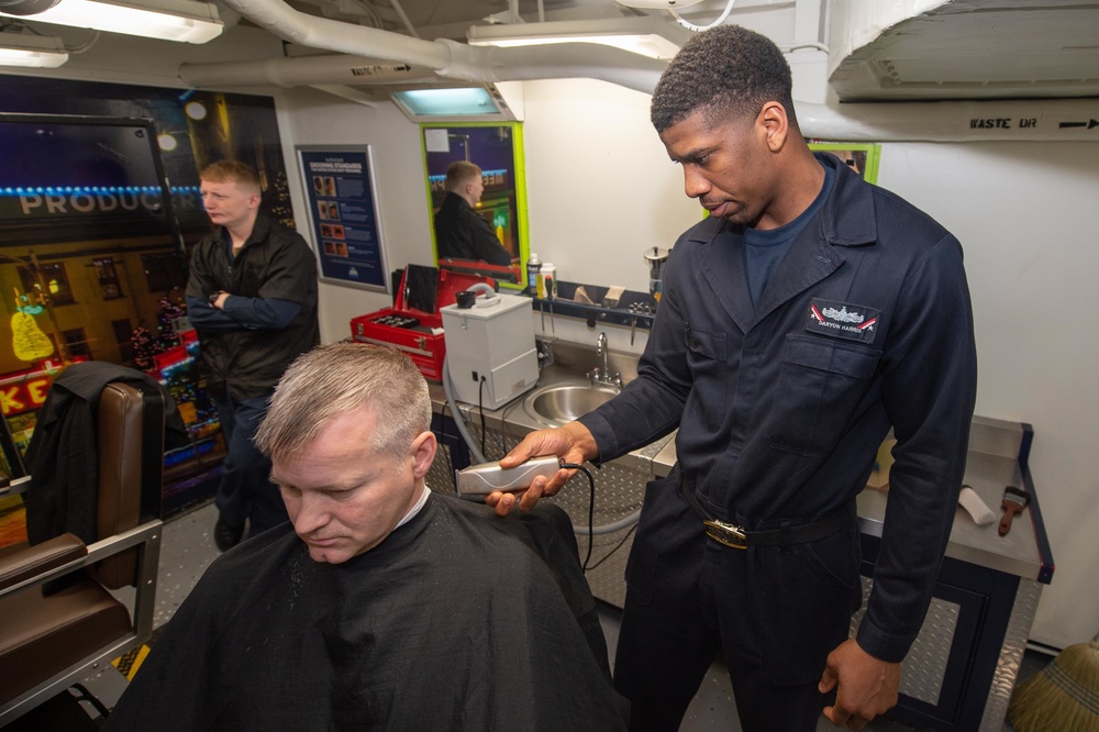 U.S. Sailor cuts commanding officer's hair