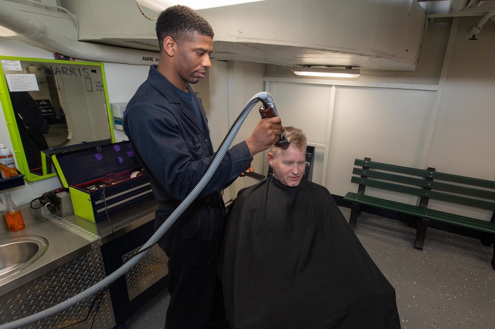 U.S. Sailor cuts commanding officer's hair