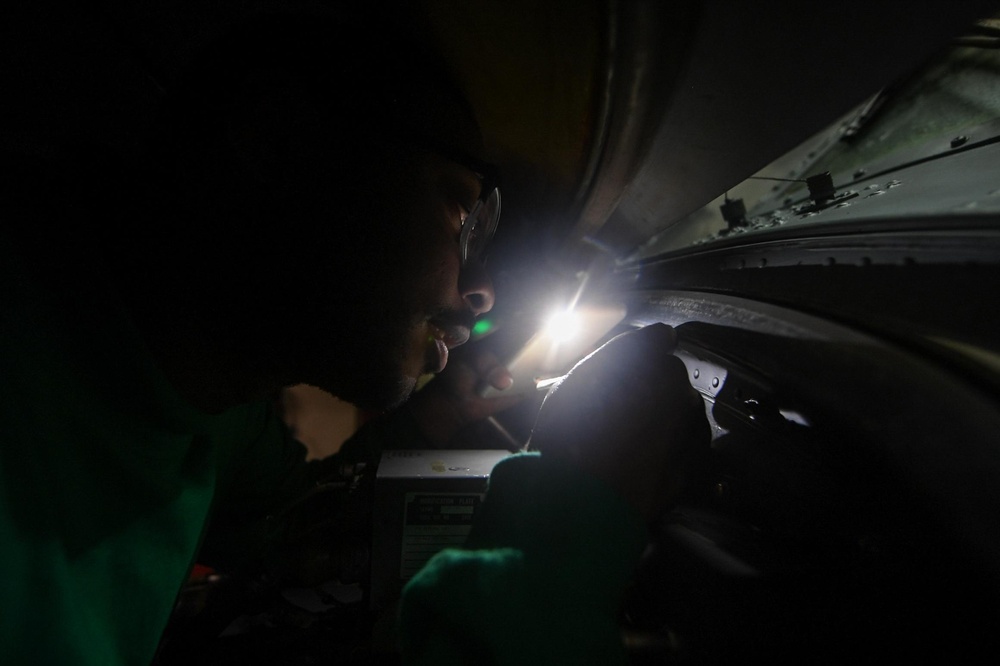 U.S. Navy Aviation Electronics Technician 2nd Class Devin Mitchell, from Woodville, Georgia, works on an MH-60R Sea Hawk