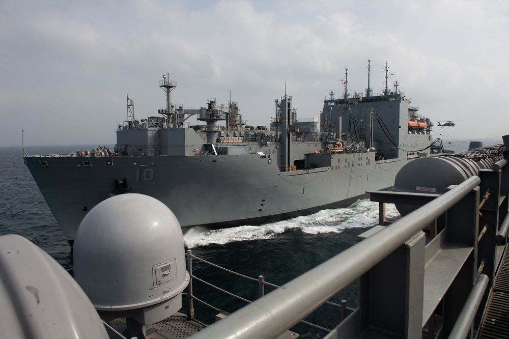 USNS Charles Drew transits alongside USS John C. Stennis during a replenishment-at-sea