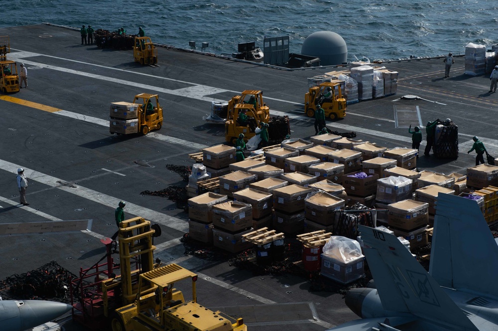 U.S. Sailors handle cargo
