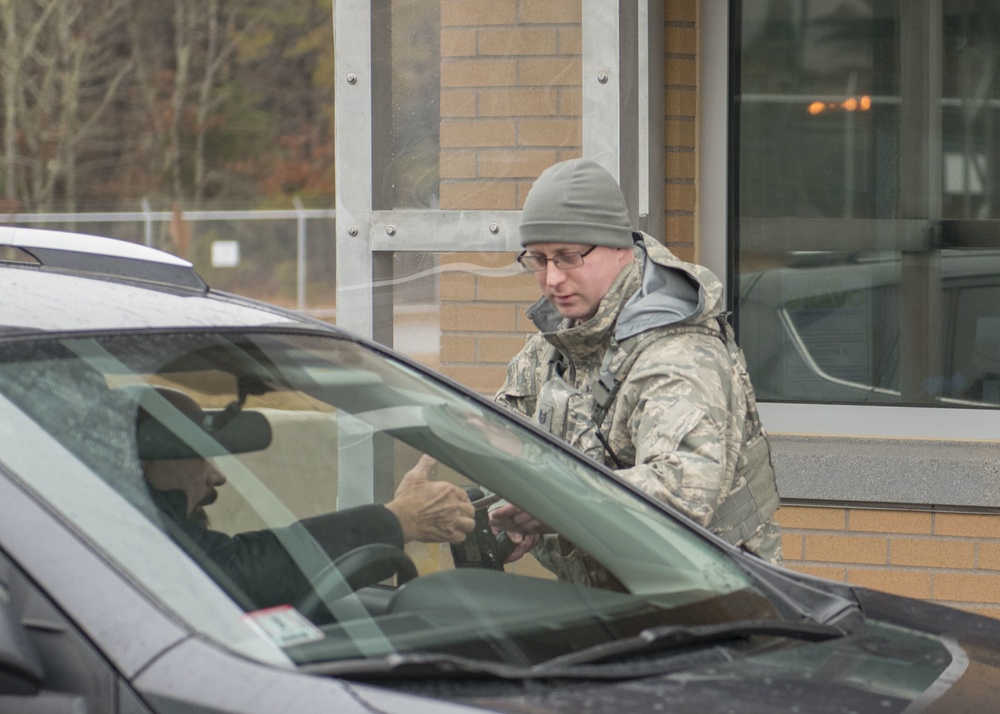 102nd Security Forces Squadron defender checks personnel identification on Joint Base Cape Cod