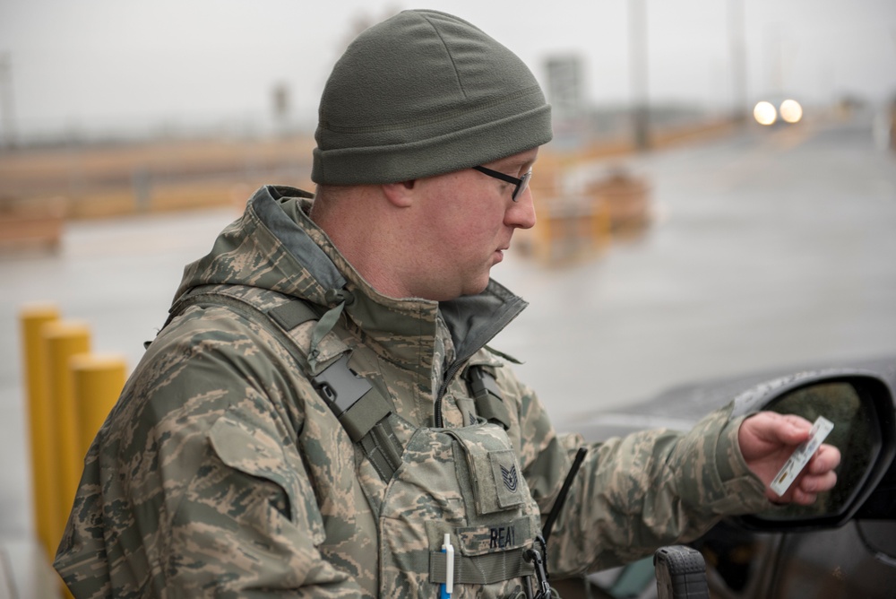 102nd Security Forces Squadron defender checks personnel identification on Joint Base Cape Cod