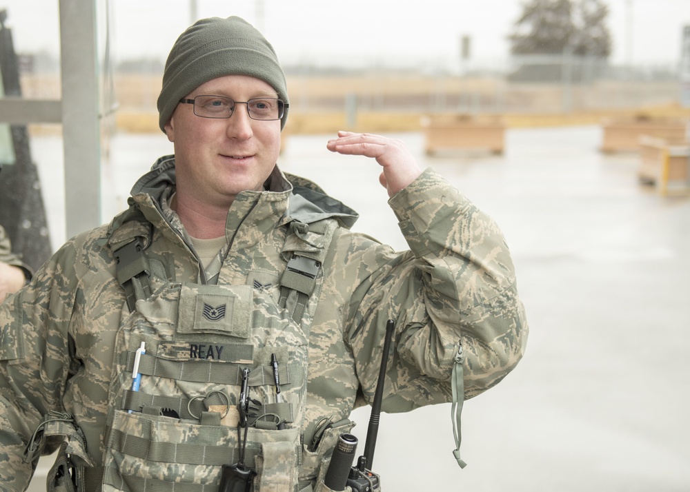 102nd Security Forces Squadron defender checks personnel identification on Joint Base Cape Cod