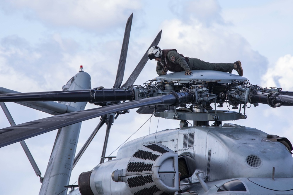 U.S. Marine inspects rotor of a CH-53E Super Stallion