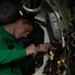 U.S. Sailor conducts maintenance in the hangar bay