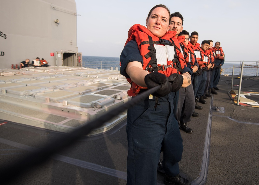 U.S. Navy Information Systems Technician 1st Class Miranda Papineau, from Paw Tuckett, Rhode Island, handles the phone and distance line