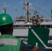 U.S. Navy Seaman Aman Pace, from Orangeburg, South Carolina, signals from USS Chung-Hoon