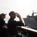 U.S. Navy Capt. Robert Bryans Jr., from Cohohes, New York, salutes to the dry cargo and ammunition ship USNS Charles Drew (T-AKE 10)