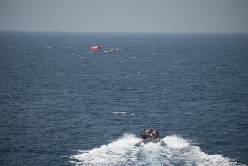 U.S. Sailors assigned to USS Chung-Hoon (DDG 93) transit toward a dhow in the Gulf of Aden