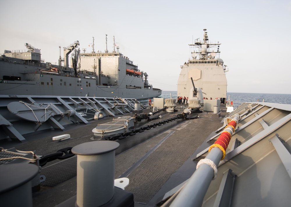 The guided-missile cruiser USS Mobile Bay (CG 53) conducts a vertical replenishment