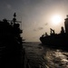 The guided-missile cruiser USS Mobile Bay (CG 53) conducts a vertical replenishment with the dry cargo and ammunition Ship USNS Charles Drew