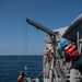 U.S. Sailors handle lines to raise a rigid-hull inflatable boat onto USS Chung-Hoon (DDG 93) in the Gulf of Aden