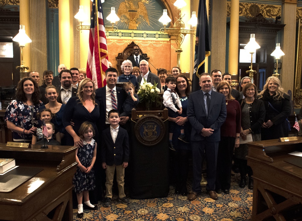 Chief Warrant Officer 2 Tom Barrett and his family following his swearing in as a Michigan Senator