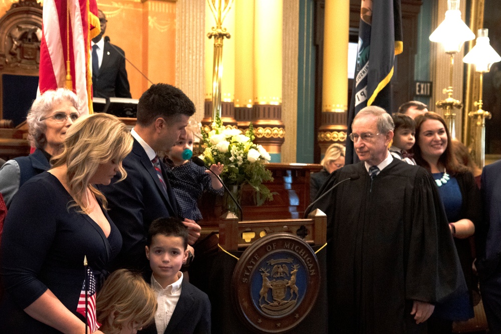 Chief Warrant Officer 2 Tom Barrett and his family and supporters before his swearing-in