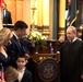 Chief Warrant Officer 2 Tom Barrett and his family and supporters before his swearing-in