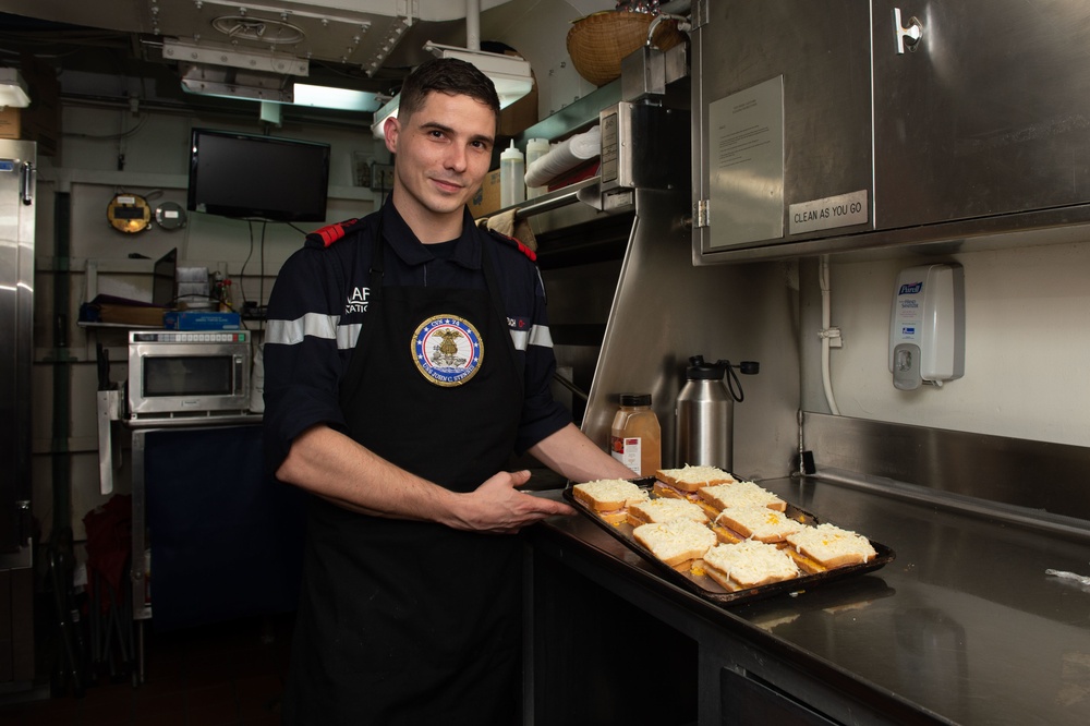 French Sailor poses for a photo aboard the aircraft carrier USS John C. Stennis (CVN 74)